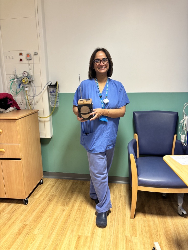 Radiology colleague showing off a DAB radio funded by CHFT Charity.